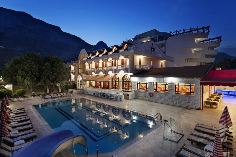 Nočni pogled na osvetljen hotelski bazen in arhitekturo