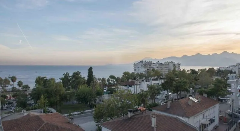 Pogled z višjega nadstropja hotela na strehe Antalye in morje v daljavi